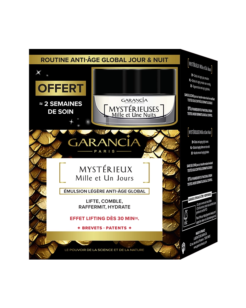 Coffret "Routine Anti-Âge Global Jour & Nuit" de Garancia. L'emballage présente le soin principal "Mystérieux Mille et Un Jours" (émulsion légère liftante et raffermissante avec effet lifting dès 30 min) et annonce en haut à gauche un produit offert : "Mystérieuses Mille et Une Nuits", correspondant à environ 2 semaines de soin. Le design du coffret est noir et or avec des motifs d'écailles de serpent dorées.